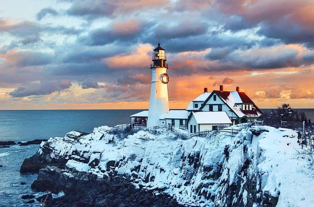Aerial view of Portland Head Light lighthouse on rocky Maine coastline